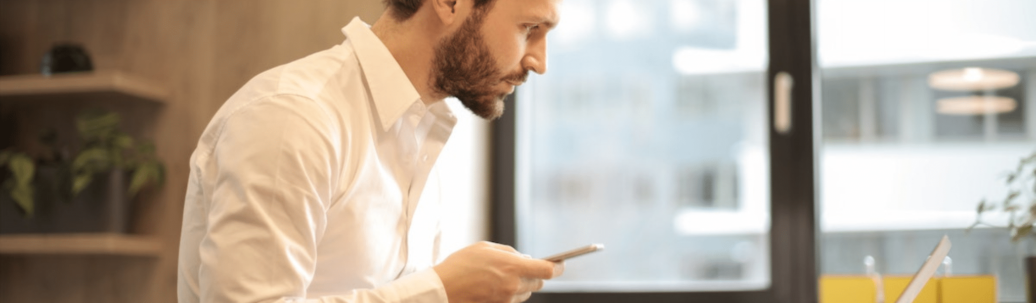 Salesman on mobile device in White Dress Shirt