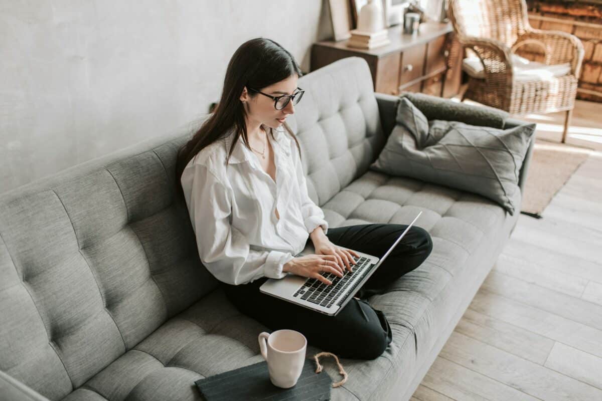 Woman on couch using computer