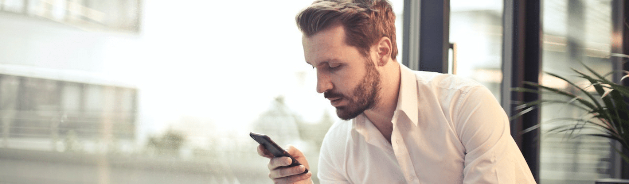 Businessman texting on phone