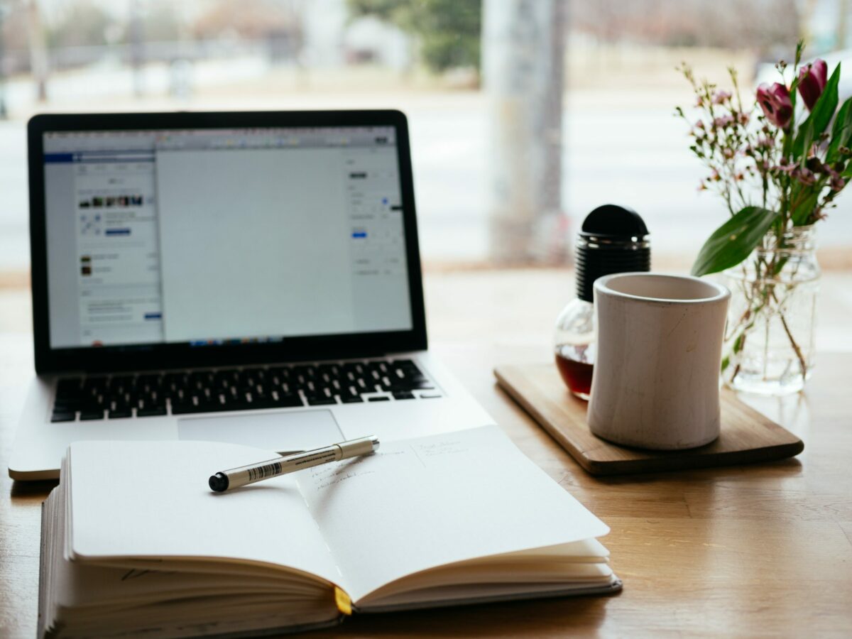 Computer with notebook on a desk