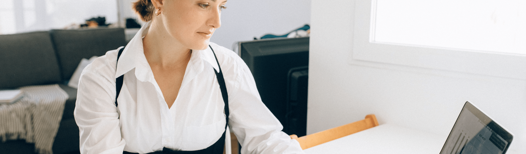 Woman in office looking at laptop