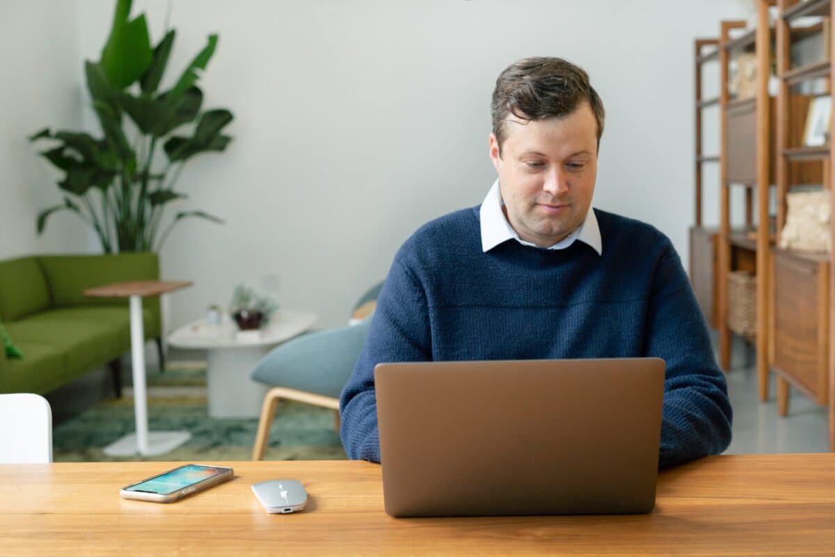 A salesman Using a Laptop Indoors